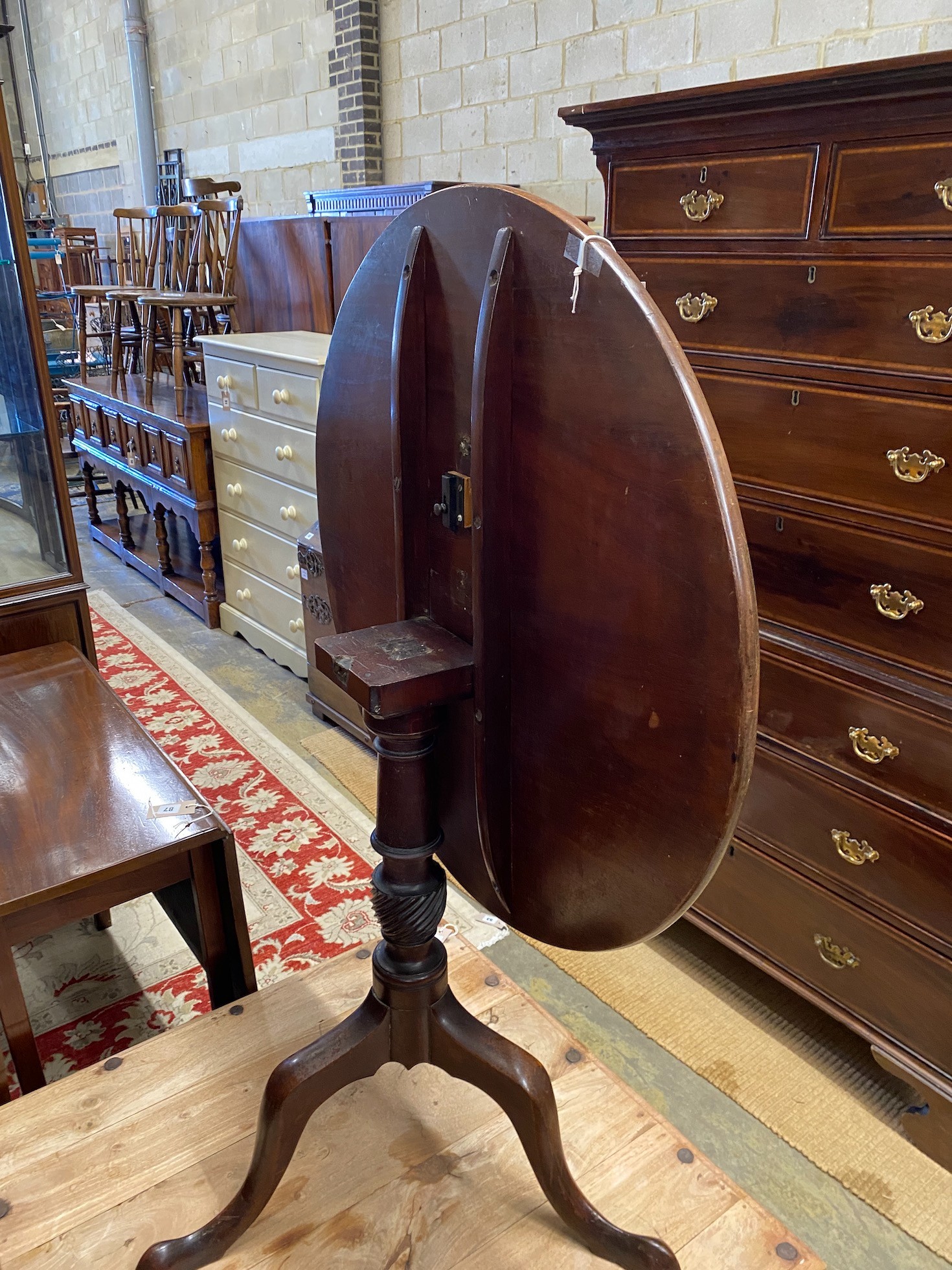 A George III mahogany circular tilt top tripod tea table, diameter 78cm, height 72cm